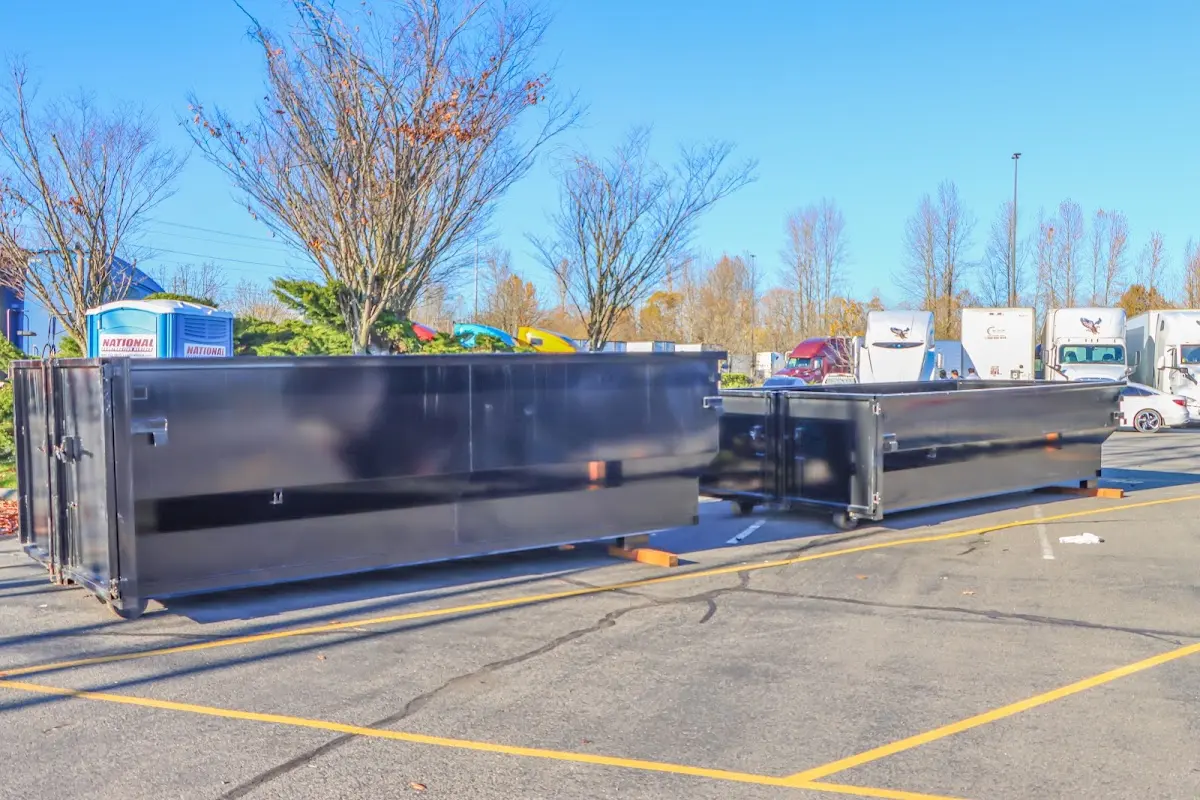 Professional dumpster rental service with roll-off container on residential driveway in Ham Lake